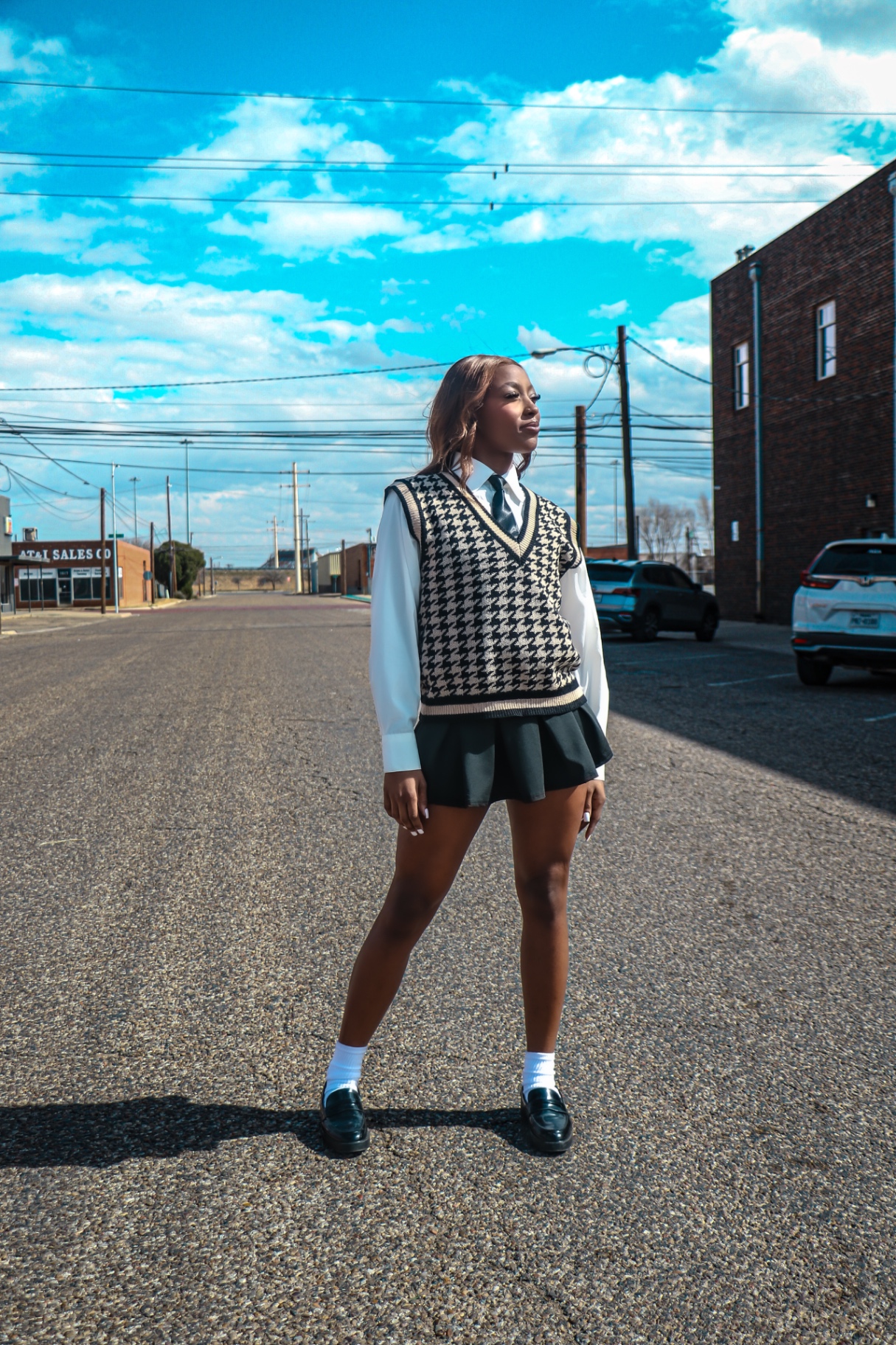 Full-length downtown street portrait under open sky