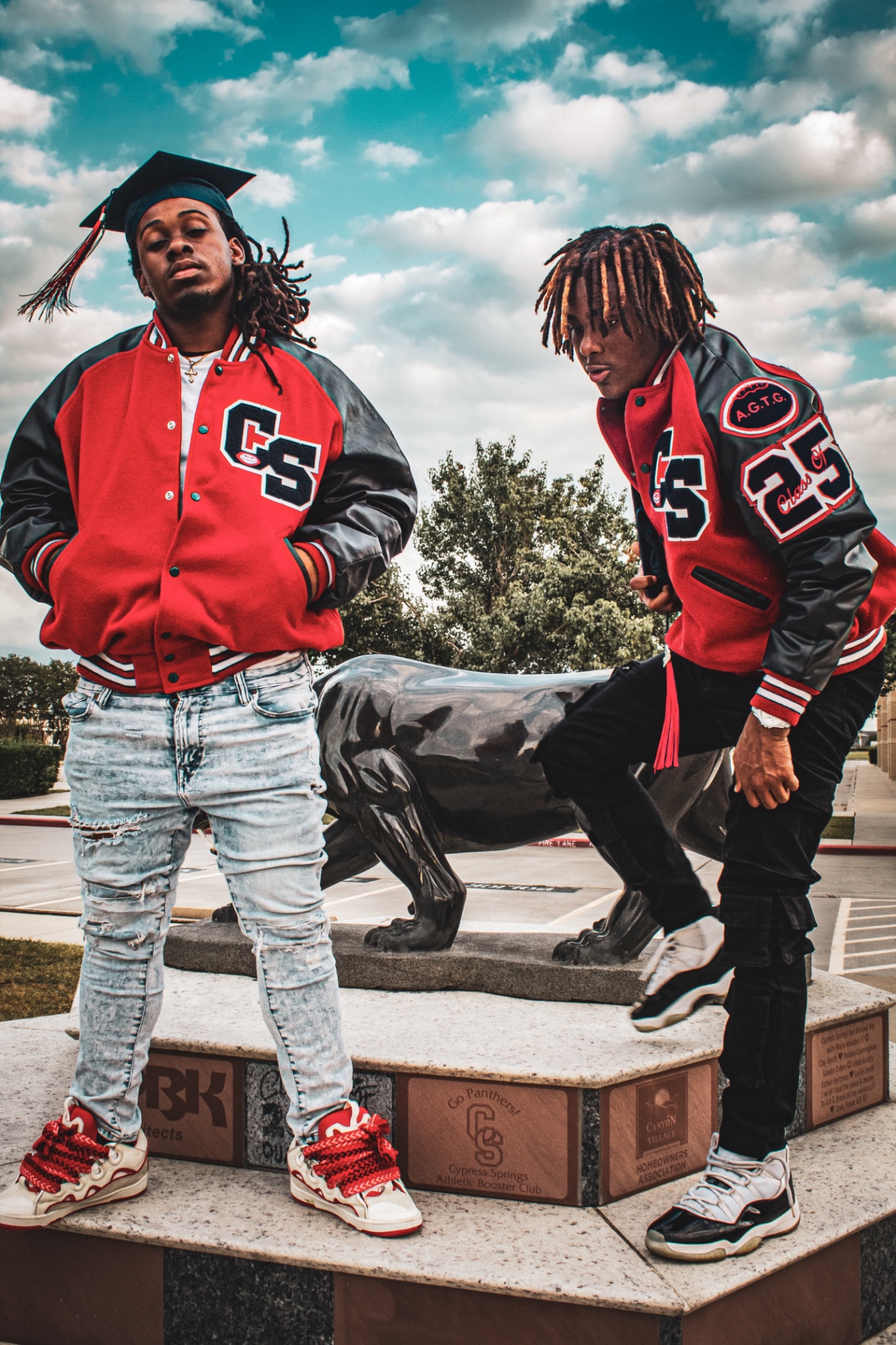Senior graduation session — two grads in letterman jackets at Cypress Springs